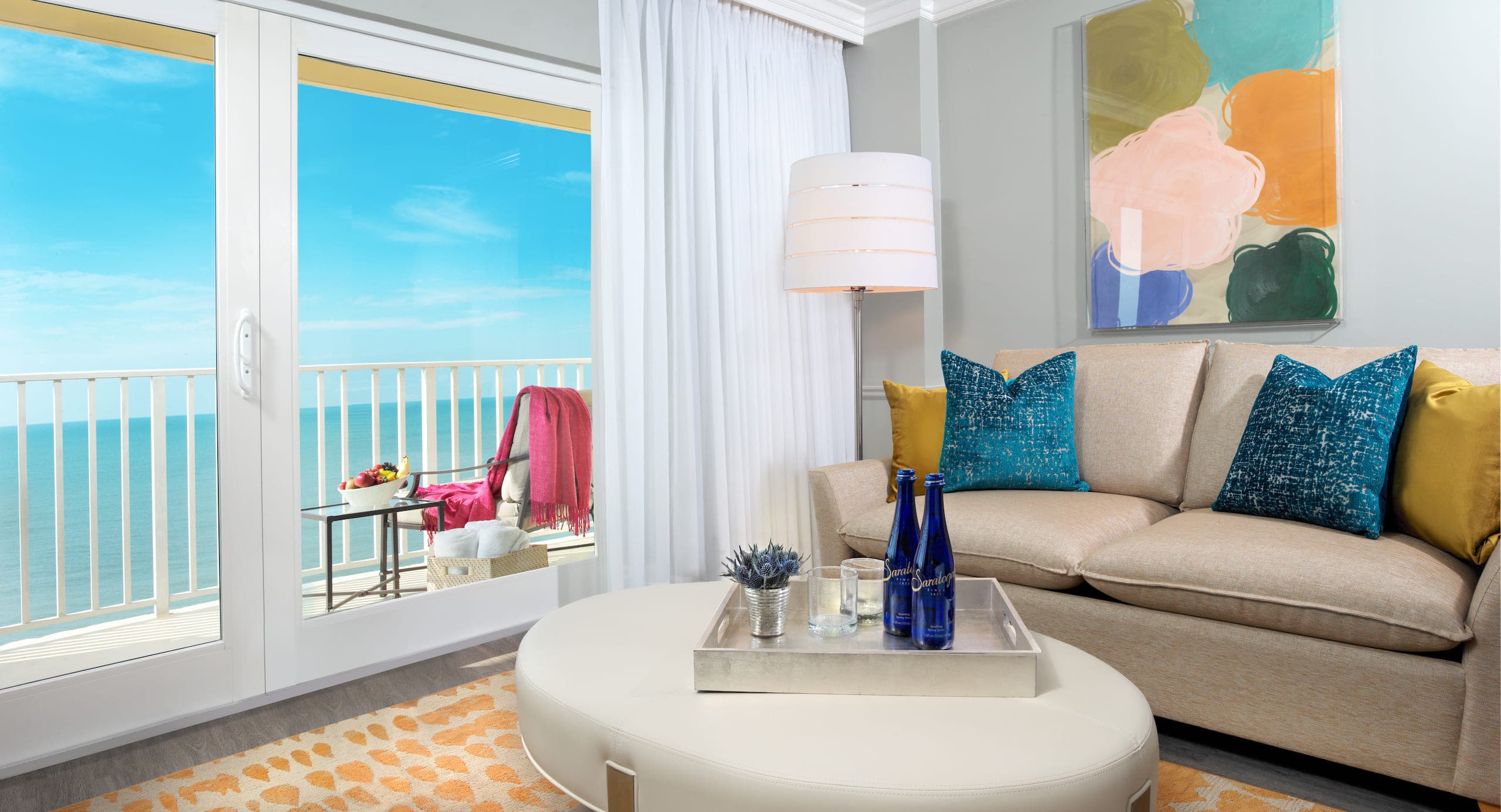 The living space a Gulf Tower room with a view of the water and a balcony