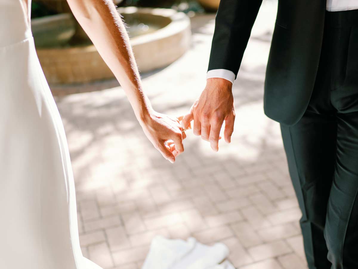 real bride and groom holding hands