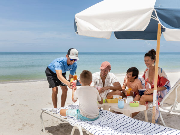 Server Serving A Family On The Beach